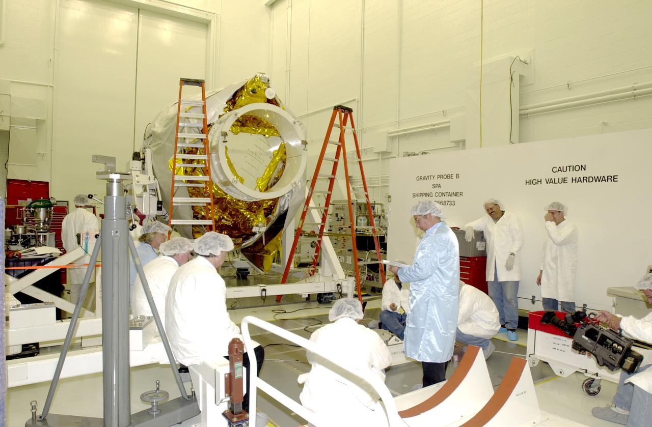 Workers in the spacecraft processing facility on North Vandenberg Air Force Base get ready to begin processing the Gravity Probe B experiment. Mechanical and electrical ground support equipment will be set up and necessary connections made with the spacecraft. Spacecraft battery conditioning will also begin. The Gravity Probe B will launch a payload of four gyroscopes into low-Earth polar orbit to test two extraordinary predictions of Albert Einstein’s general theory of relativity: the geodetic effect (how space and time are warped by the presence of the Earth) and frame dragging (how Earth’s rotation drags space and time around with it). Once in orbit, for 18 months each gyroscope’s spin axis will be monitored as it travels through local spacetime, observing and measuring these effects. The experiment was developed by Stanford University, Lockheed Martin and NASA’s Marshall Space Flight Center.