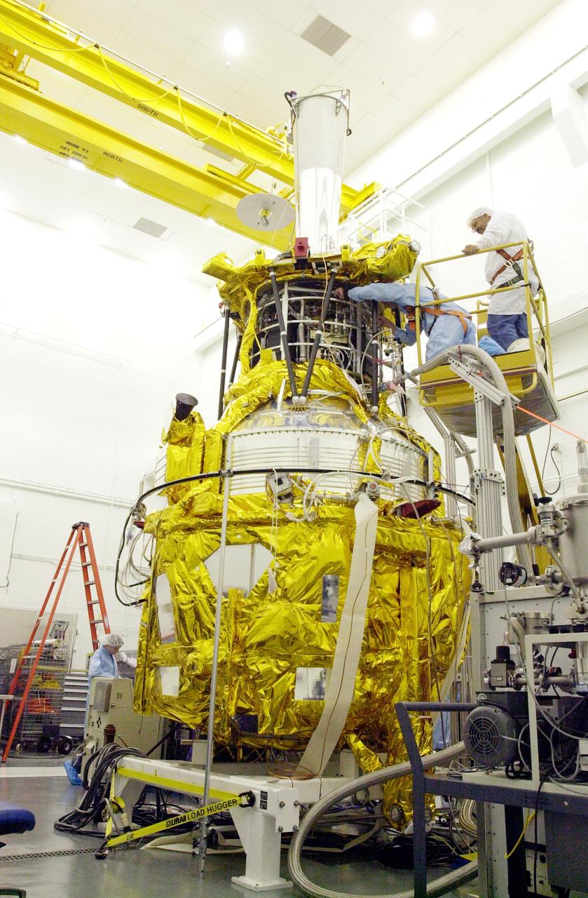 In the spacecraft processing facility on North Vandenberg Air Force Base, workers conduct battery charge/discharge cycles as part of the battery conditioning process on Gravity Probe B. The Gravity Probe B will launch a payload of four gyroscopes into low-Earth polar orbit to test two extraordinary predictions of Albert Einstein’s general theory of relativity: the geodetic effect (how space and time are warped by the presence of the Earth) and frame dragging (how Earth’s rotation drags space and time around with it). Once in orbit, for 18 months each gyroscope’s spin axis will be monitored as it travels through local spacetime, observing and measuring these effects. The experiment was developed by Stanford University, Lockheed Martin and NASA’s Marshall Space Flight Center.