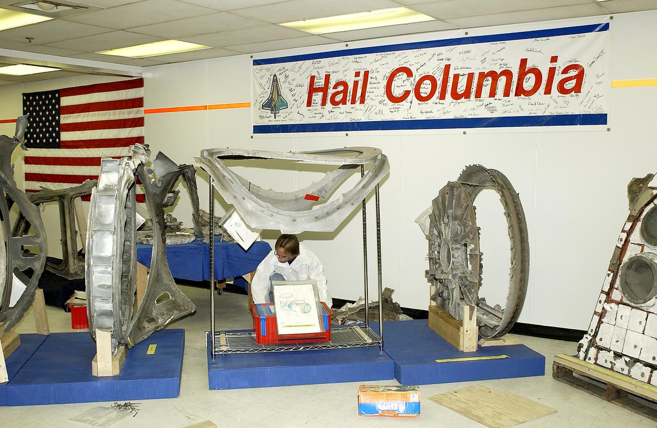 Richard Risley, with United Space Alliance, places a box of Columbia debris in its final resting place in the Vehicle Assembly Building (VAB). All of the pieces received and collected in the Columbia Reconstruction Hangar have been catalogued and moved to a permanent site in the VAB.