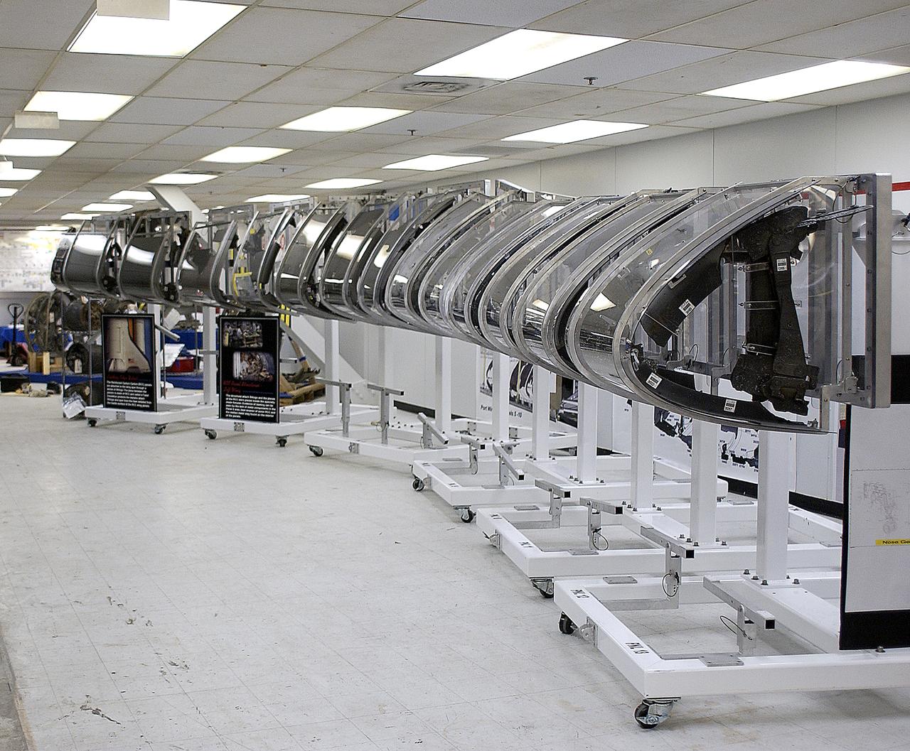 In the Vehicle Assembly Building, the mockup of the leading edge of Columbia’s left wing takes its place among the rest of the debris. All of the pieces received and collected in the Columbia Reconstruction Hangar have been catalogued and moved to a permanent site in the VAB.