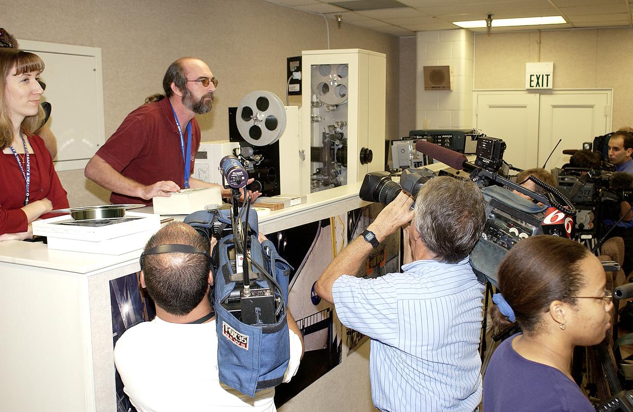 In the Image Analysis Facility in the Vehicle Assembly Building, Brad Lawrence (second from left, standing) participates in a presentation to news media representatives on the improved tracking cameras and long-range optical tracking systems that will be used to capture ascent imagery during the return to flight of the Space Shuttle. The press opportunity also includes tours of the launch pad perimeter camera site at Launch Complex 39B and two Playalinda Beach optical tracking sites at the Cape Canaveral National Seashore and the Merritt Island National Refuge.