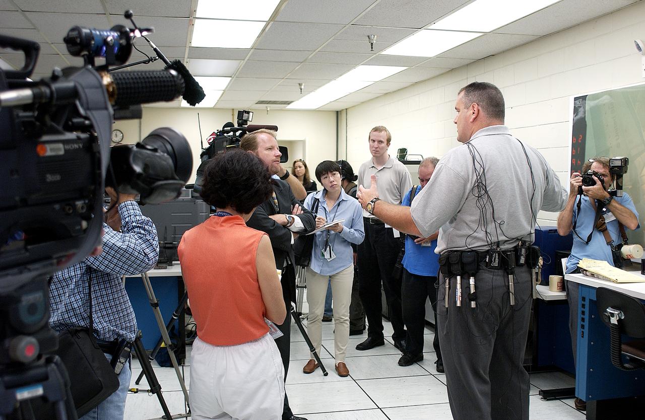 In the Image Analysis Facility in the Vehicle Assembly Building, Armando Oliu (second from right), lead of the KSC Ice and Debris Team, answers questions from news media representatives on the improved tracking cameras and long-range optical tracking systems that will be used to capture ascent imagery during the return to flight of the Space Shuttle. The press opportunity also includes tours of the launch pad perimeter camera site at Launch Complex 39B and two Playalinda Beach optical tracking sites at the Cape Canaveral National Seashore and the Merritt Island National Refuge.