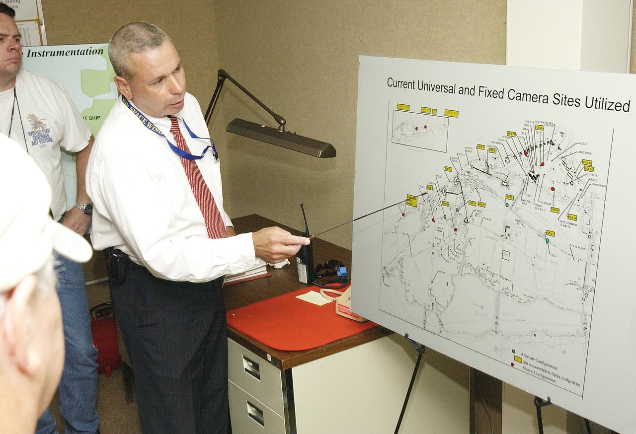 Inside the dome building at Playalinda Beach, Bob Fore points to a map of camera sites during a presentation to the media on the improved tracking cameras and long-range optical tracking systems that will be used to capture ascent imagery during the return to flight of the Space Shuttle. The press opportunity also includes tours of the launch pad perimeter camera site at Launch Complex 39B and the other optical tracking site at the Merritt Island National Refuge.