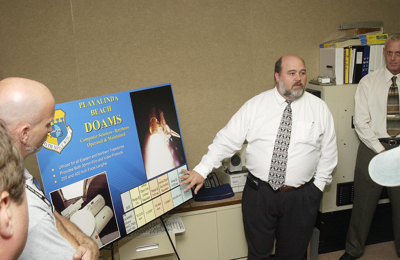 Inside the dome building at Playalinda Beach, Mike Litscher talks to media about the Distant Object Attitude Measurement System (DOAMS), part of the improved tracking cameras and long-range optical tracking systems that will be used to capture ascent imagery during the return to flight of the Space Shuttle. The press opportunity also includes tours of the launch pad perimeter camera site at Launch Complex 39B and the other optical tracking site at the Merritt Island National Refuge.
