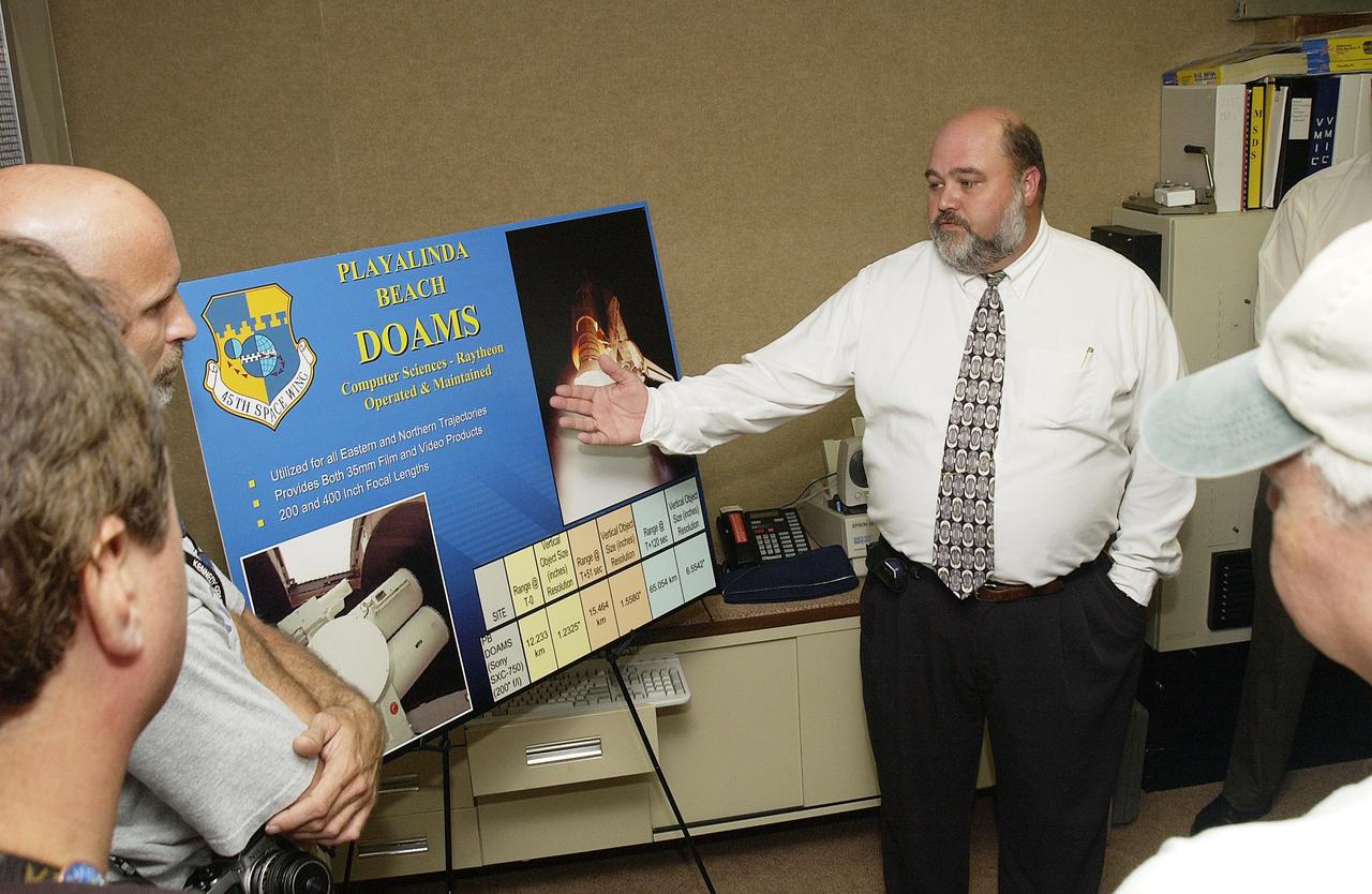 Inside the dome building at Playalinda Beach, Mike Litscher talks to media about the Distant Object Attitude Measurement System (DOAMS), part of the improved tracking cameras and long-range optical tracking systems that will be used to capture ascent imagery during the return to flight of the Space Shuttle. The press opportunity also includes tours of the launch pad perimeter camera site at Launch Complex 39B and the other optical tracking site at the Merritt Island National Refuge.