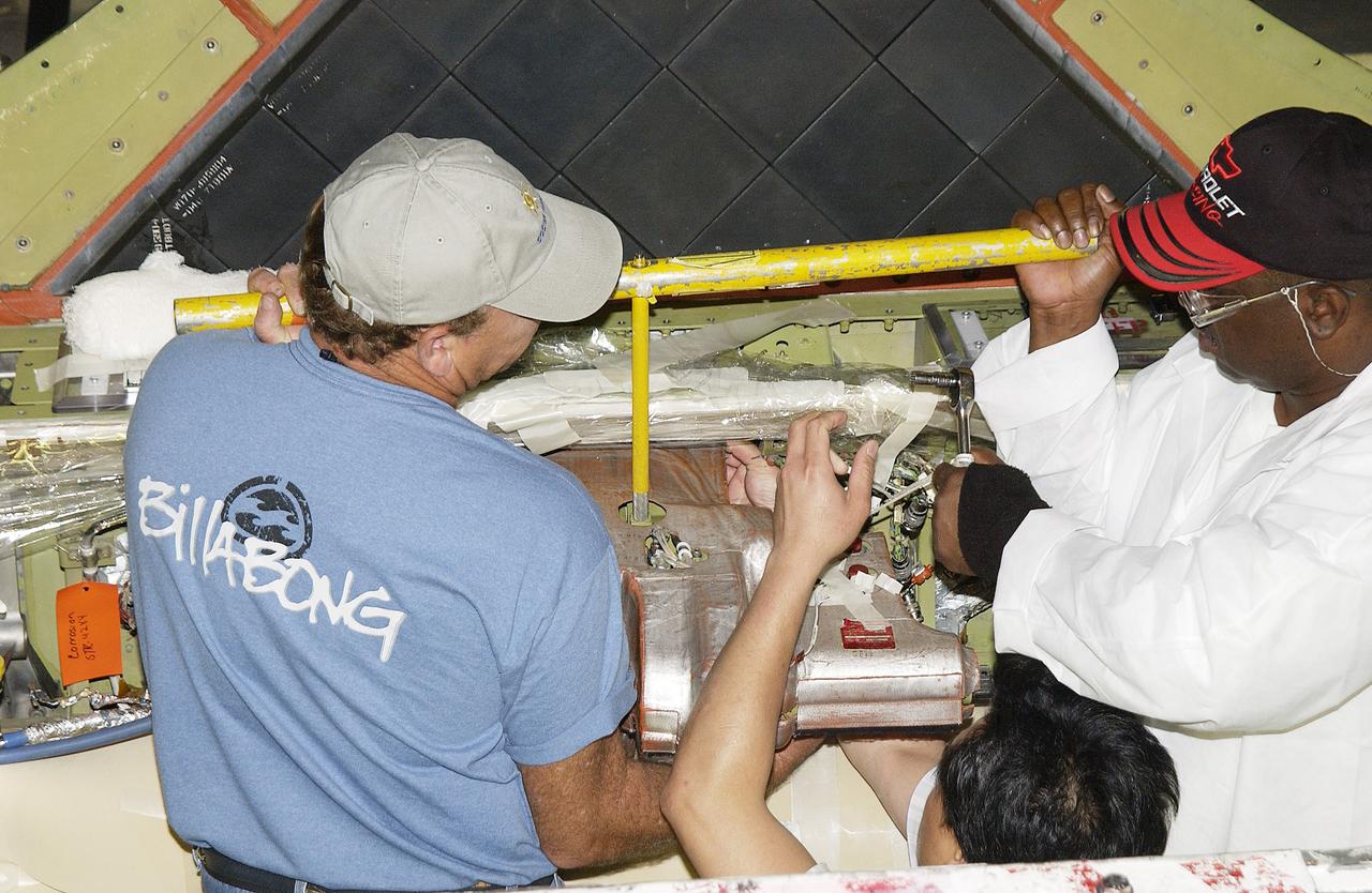 In the Orbiter Processing Facility, (from left) Tim Chastain, Sang Huynh and John Peterson, with United Space Alliance, work at removing the body flap actuator from the orbiter Endeavour. The work is part of return to flight activities on the orbiter fleet. 