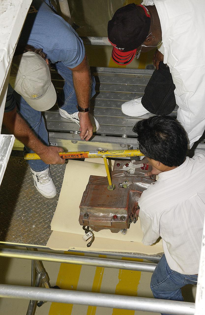 (Clockwise from left), in the Orbiter Processing Facility, Tim Chastain, John Peterson and Sang Huynh, with United Space Alliance, work at removing the body flap actuator from the orbiter Endeavour. The work is part of return to flight activities on the orbiter fleet. 