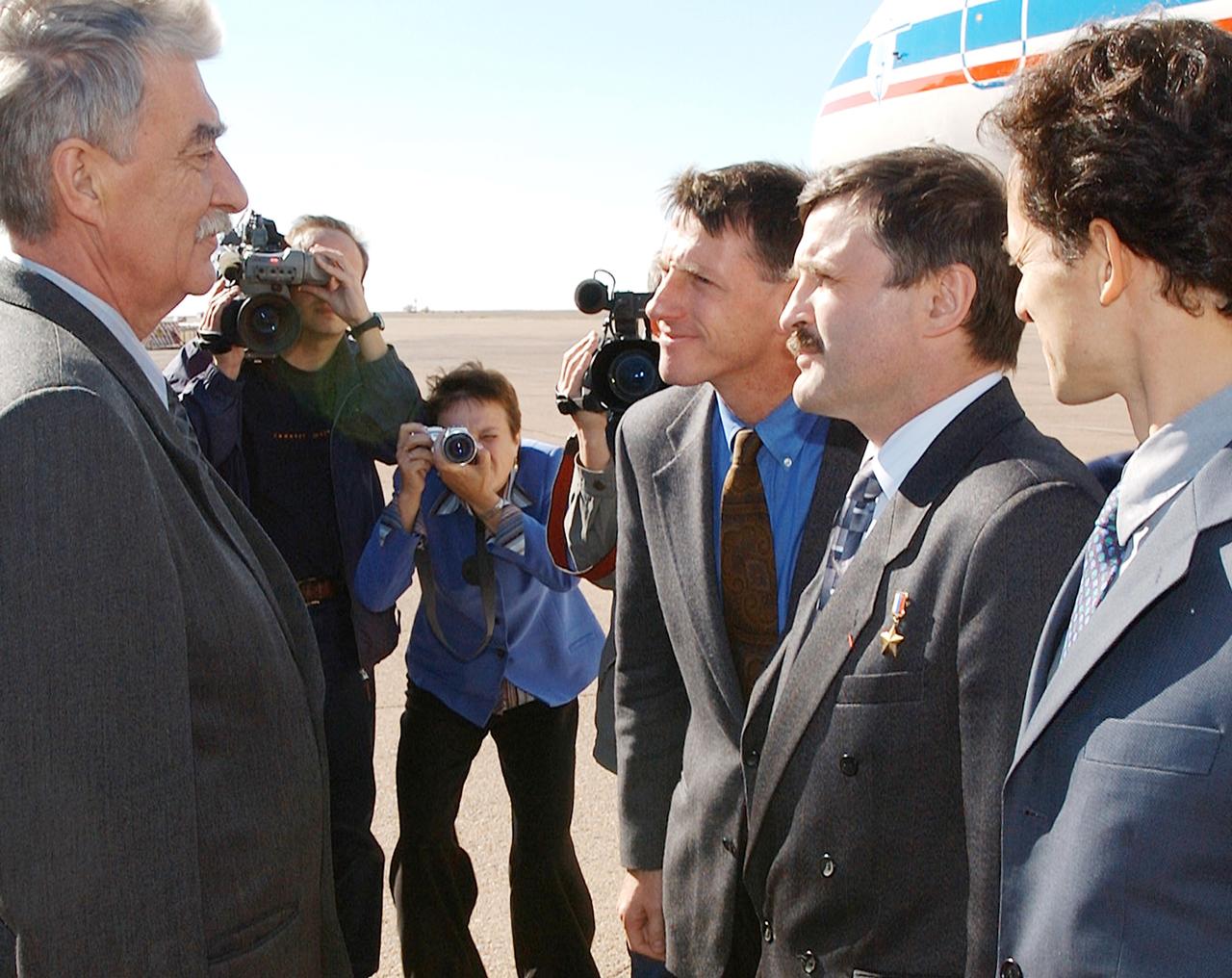 Baikonur, Kazakhstan - Victor Grin (left), a member of the Russian State Commission, greets (left to right) Expedition 8 Commander Michael Foale, Expedition 8 Soyuz Commander and Flight Engineer Alexander Kaleri and European Space Agency Astronaut Pedro Duque of Spain. Expedition 8 is scheduled to launch from the Baikonur Cosmodrome in Kazakhstan on Oct.18 on board a Soyuz rocket to the International Space Station. Photo Credit: "NASA/Bill Ingalls"