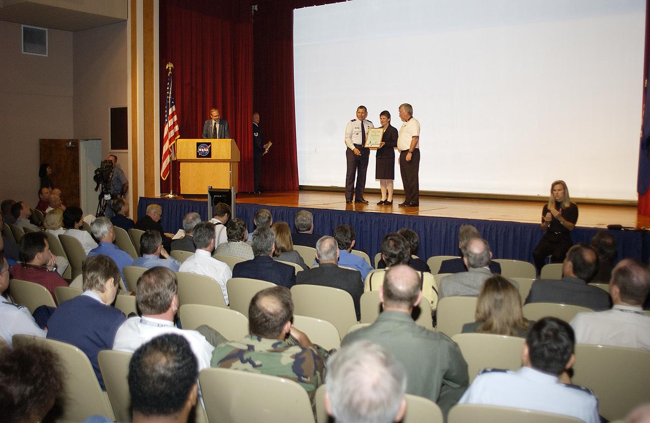 Brig. Gen. J. Gregory Pavlovich (left), 45th Space Wing, and Center Director Jim Kennedy (right) present one of several individual safety awards given on Spaceport Super Safety and Health Day.  An annual event at KSC and Cape Canaveral Air Force Station,  Spaceport Super Safety and Health Day is dedicated to reinforcing safe and healthful behaviors in the workforce.