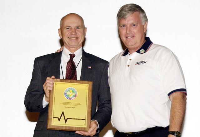KENNEDY SPACE CENTER, FLA. -     Center Director Jim Kennedy (right) presents a plaque to Conrad Nagel who organized the Spaceport Super Safety and Health Day at KSC, an annual event dedicated to reinforcing safe and healthful behaviors in the workforce.  Nagel is chief of the Shuttle Project Office, Shuttle Processing.