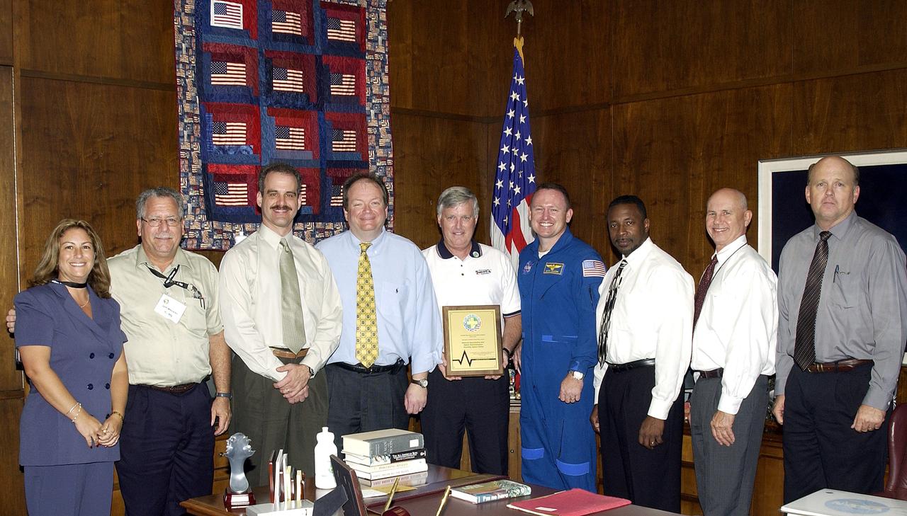 KENNEDY SPACE CENTER, FLA. -  Center Director Jim Kennedy (center) shares the kudos for Spaceport Super Safety and Health Day with members of the coordinating committee.  Astronaut Barry E. Wilmore (at right) presented the award to Kennedy.  Next to Wilmore at right is Dr. Woodrow Whitlow, KSC’s deputy director.