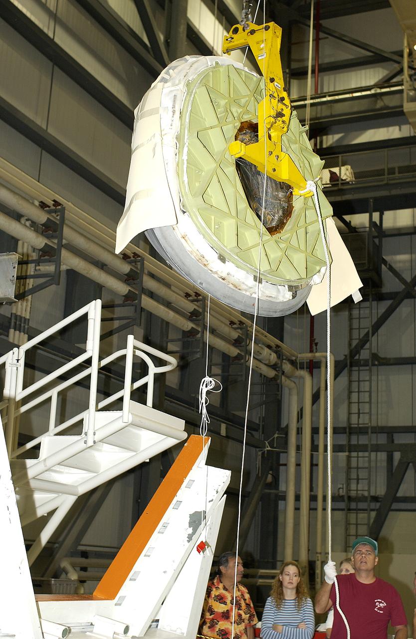 KENNEDY SPACE CENTER, FLA. - In the Orbiter Processing Facility, the nose cap of the orbiter Atlantis is lifted for its transfer to a stand.  The cap was removed for routine inspection. The nose cap is made of reinforced carbon-carbon (RCC), which has an operating range of minus 250° F to about 3,000° F.