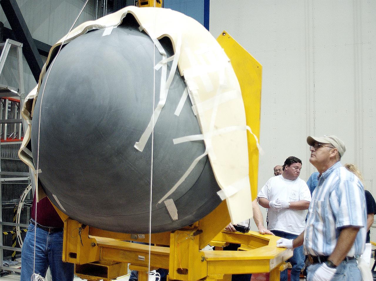 KENNEDY SPACE CENTER, FLA. -  In the Orbiter Processing Facility, the nose cap of the orbiter Atlantis rests on a stand after its removal from the orbiter for routine inspection. The nose cap is made of reinforced carbon-carbon (RCC), which has an operating range of minus 250° F to about 3,000° F.
