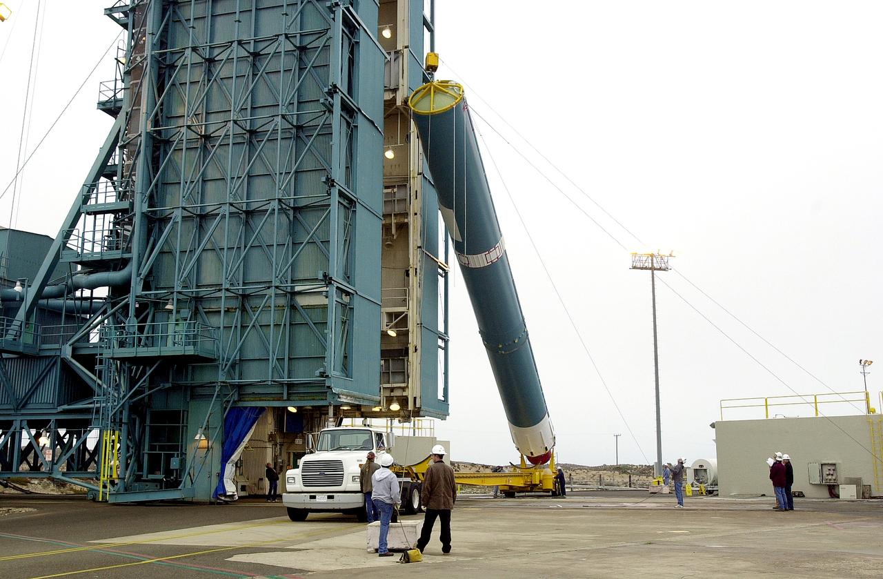 VANDENBERG AFB, CALIF. -  The first stage of the Delta II launch vehicle for the Gravity Probe B experiment is raised to a vertical position at Space Launch Complex 2, Vandenberg Air Force Base, Calif.  The Gravity Probe B will launch a payload of four gyroscopes into low-Earth polar orbit to test two extraordinary predictions of Albert Einstein’s general theory of relativity: the geodetic effect (how space and time are warped by the presence of the Earth) and frame dragging (how Earth’s rotation drags space and time around with it). Once in orbit, for 18 months each gyroscope’s spin axis will be monitored as it travels through local spacetime, observing and measuring these effects.  The experiment was developed by Stanford University, Lockheed Martin and NASA’s Marshall Space Flight Center.  The targeted launch date is Dec. 6, 2003.