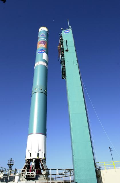 NASA image: VANDENBERG AFB, CALIF. -  The mobile service tower on Space Launch Complex 2, Vandenberg Air Force Base, Calif., rolls back from the Delta II rocket that will launch the Gravity Probe B experiment.  The Gravity Probe B will launch a payload of four gyroscopes into low-Earth polar orbit to test two extraordinary predictions of Albert Einstein’s general theory of relativity: the geodetic effect (how space and time are warped by the presence of the Earth) and frame dragging (how Earth’s rotation drags space and time around with it). Once in orbit, for 18 months each gyroscope’s spin axis will be monitored as it travels through local spacetime, observing and measuring these effects.  The experiment was developed by Stanford University, Lockheed Martin and NASA’s Marshall Space Flight Center.  The targeted launch date is Dec. 6, 2003.