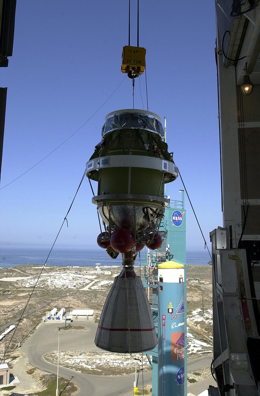 VANDENBERG AFB, CALIF. -  Viewed from inside, the second stage of the Delta II launch vehicle for the Gravity Probe B experiment is lifted up the mobile service tower on Space Launch Complex 2, Vandenberg Air Force Base, Calif.   Behind it is the first stage of the Delta II.  The Gravity Probe B will launch a payload of four gyroscopes into low-Earth polar orbit to test two extraordinary predictions of Albert Einstein’s general theory of relativity: the geodetic effect (how space and time are warped by the presence of the Earth) and frame dragging (how Earth’s rotation drags space and time around with it). Once in orbit, for 18 months each gyroscope’s spin axis will be monitored as it travels through local spacetime, observing and measuring these effects.  The experiment was developed by Stanford University, Lockheed Martin and NASA’s Marshall Space Flight Center.  The targeted launch date is Dec. 6, 2003.