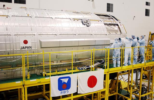 NASA image: KENNEDY SPACE CENTER, FLA. -  In the Space Station Processing Facility, STS-115 Mission Specialist Joseph Tanner and STS-117 Mission Specialist James Reilly get a close look at the Japanese Experiment Module (JEM).  Reilly and Tanner are at KSC for equipment familiarization, a routine part of astronaut training and launch preparations.