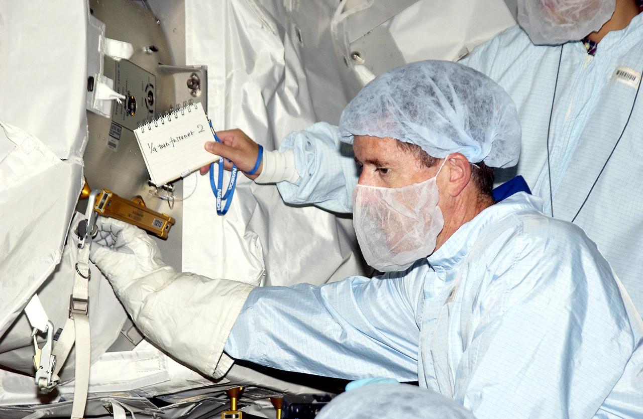 KENNEDY SPACE CENTER, FLA. - In the Space Station Processing Facility, STS-117 Mission Specialist James Reilly  works with equipment in the Japanese Experiment Module (JEM) as part of training for ExtraVehicular Activity (EVA).  Equipment familiarization is a routine part of astronaut training and launch preparations.