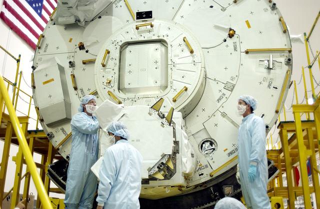 NASA image: KENNEDY SPACE CENTER, FLA. - In the Space Station Processing Facility, STS-115 Mission Specialist Joseph Tanner (left) and STS-117 Mission Specialist James Reilly (right) look over the Japanese Experiment Module (JEM) behind them. Equipment familiarization is a routine part of astronaut training and launch preparations.