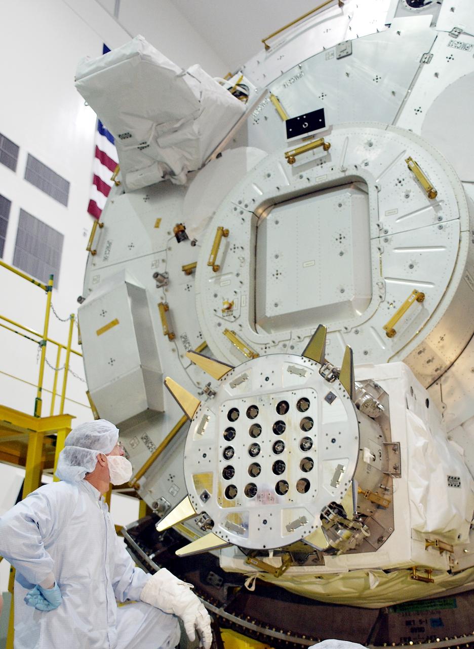 KENNEDY SPACE CENTER, FLA. - In the Space Station Processing Facility, STS-115 Mission Specialist Joseph Tanner looks at the Exposed Facility Berthing Mechanism (EFBM)  on the Japanese Experiment Module (JEM), after removing its cover.  Equipment familiarization is a routine part of astronaut training and launch preparations.