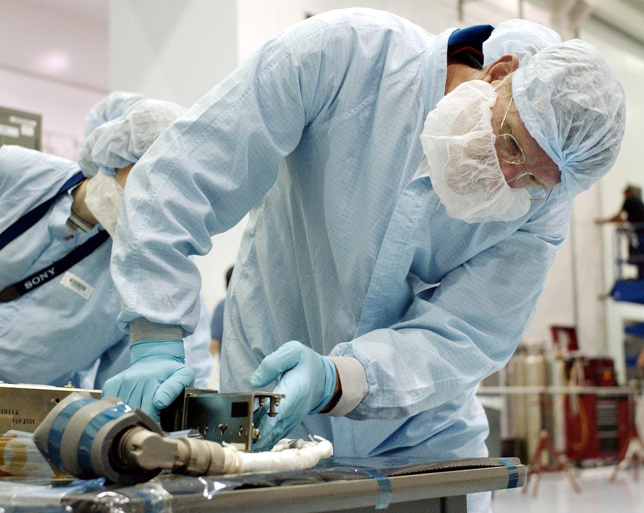 KENNEDY SPACE CENTER, FLA. - STS-115 Mission Specialist Joseph Tanner checks out a camera for the Japanese Experiment Module (JEM) in the Space Station Processing Facility. Known as Kibo, the JEM consists of six components: two research facilities -- the Pressurized Module and the Exposed Facility; a Logistics Module attached to each of them; a Remote Manipulator System; and an Inter-Orbit Communication System unit. Kibo also has a scientific airlock through which experiments are transferred and exposed to the external environment of space. The various components of JEM will be assembled in space over the course of three Space Shuttle missions. Equipment familiarization is a routine part of astronaut training and launch preparations.