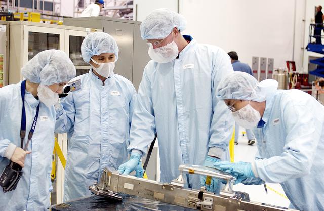 KENNEDY SPACE CENTER, FLA. - STS-115 Mission Specialist Joseph Tanner (second from right) checks out a camera and cables for the Japanese Experiment Module (JEM) in the Space Station Processing Facility. Known as Kibo, the JEM consists of six components: two research facilities - the Pressurized Module and the Exposed Facility; a Logistics Module attached to each of them; a Remote Manipulator System; and an Inter-Orbit Communication System unit. Kibo also has a scientific airlock through which experiments are transferred and exposed to the external environment of space. The various components of JEM will be assembled in space over the course of three Space Shuttle missions. Equipment familiarization is a routine part of astronaut training and launch preparations.