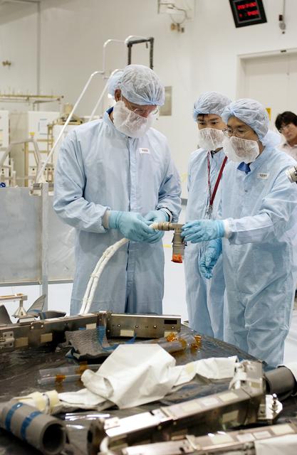 NASA image: KENNEDY SPACE CENTER, FLA. -  In the Space Station Processing Facility, STS-115 Mission Specialist Joseph Tanner (left)  checks out a camera and cables to be used in the Japanese Experiment Module (JEM). Known as Kibo, the JEM consists of six components: two research facilities - the Pressurized Module and the Exposed Facility; a Logistics Module attached to each of them; a Remote Manipulator System; and an Inter-Orbit Communication System unit. Kibo also has a scientific airlock through which experiments are transferred and exposed to the external environment of space. The various components of JEM will be assembled in space over the course of three Space Shuttle missions. Equipment familiarization is a routine part of astronaut training and launch preparations.