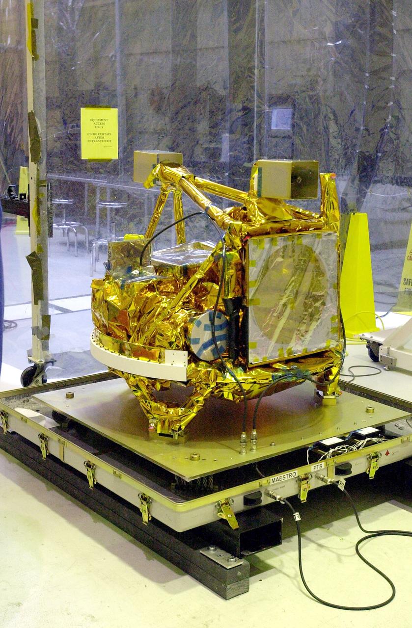 VANDENBERG AIR FORCE BASE, CALIF. - The SciSat-1 spacecraft is revealed at Vandenberg Air Force Base, Calif.   Sci-Sat, which will undergo instrument checkout and spacecraft functional testing, weighs approximately 330 pounds and after launch will be placed in a 400-mile-high polar orbit to investigate processes that control the distribution of ozone in the upper atmosphere. The data from the satellite will provide Canadian and international scientists with improved measurements relating to global ozone processes and help policymakers assess existing environmental policy and develop protective measures for improving the health of our atmosphere, preventing further ozone depletion. The mission is designed to last two years.