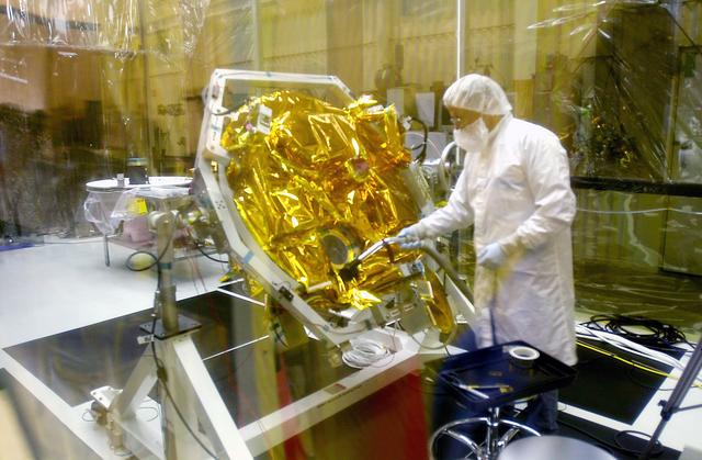 NASA image: VANDENBERG AIR FORCE BASE, CALIF.- At Vandenberg Air Force Base, Calif., spacecraft functional testing is underway on the SciSat-1. The solar arrays are being attached and the communications systems are also being checked out.   The SciSat-1 weighs approximately 330 pounds and after launch will be placed in a 400-mile-high polar orbit to investigate processes that control the distribution of ozone in the upper atmosphere. The data from the satellite will provide Canadian and international scientists with improved measurements relating to global ozone processes and help policymakers assess existing environmental policy and develop protective measures for improving the health of our atmosphere, preventing further ozone depletion. The mission is designed to last two years.