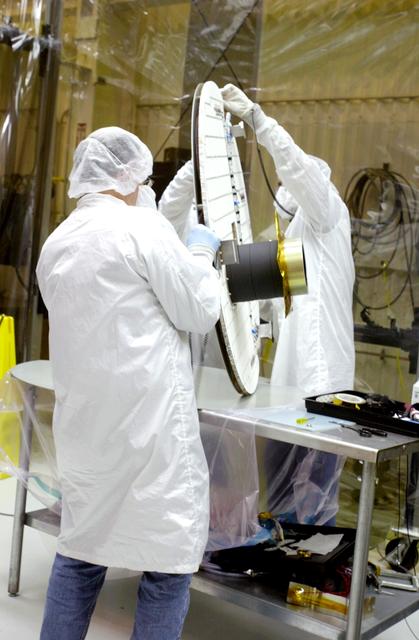 NASA image: VANDENBERG AIR FORCE BASE, CALIF.- At Vandenberg Air Force Base, Calif., spacecraft functional testing is underway on the SciSat-1. The solar arrays are being attached and the communications systems are also being checked out.   The SciSat-1 weighs approximately 330 pounds and after launch will be placed in a 400-mile-high polar orbit to investigate processes that control the distribution of ozone in the upper atmosphere. The data from the satellite will provide Canadian and international scientists with improved measurements relating to global ozone processes and help policymakers assess existing environmental policy and develop protective measures for improving the health of our atmosphere, preventing further ozone depletion. The mission is designed to last two years.