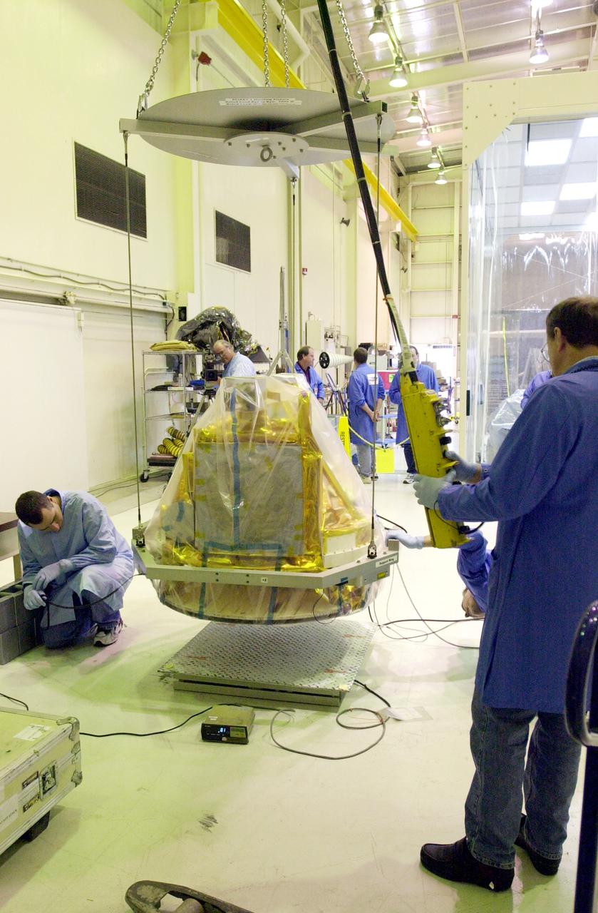 VANDENBERG AIR FORCE BASE, CALIF.-  The covered SciSat-1 spacecraft is lowered onto a test stand at Vandenberg Air Force Base, Calif., for functional testing.  The solar arrays will be attached and the communications systems checked out.   The SciSat-1 weighs approximately 330 pounds and after launch will be placed in a 400-mile-high polar orbit to investigate processes that control the distribution of ozone in the upper atmosphere. The data from the satellite will provide Canadian and international scientists with improved measurements relating to global ozone processes and help policymakers assess existing environmental policy and develop protective measures for improving the health of our atmosphere, preventing further ozone depletion. The mission is designed to last two years.