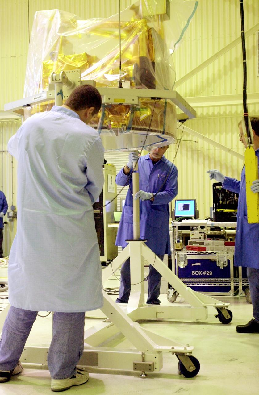 VANDENBERG AIR FORCE BASE, CALIF. -  At Vandenberg Air Force Base, Calif. a covered SciSat-1 spacecraft is lifted onto a rotation stand.   The solar arrays will be attached and the communications systems checked out.   The SciSat-1 weighs approximately 330 pounds and after launch will be placed in a 400-mile-high polar orbit to investigate processes that control the distribution of ozone in the upper atmosphere. The data from the satellite will provide Canadian and international scientists with improved measurements relating to global ozone processes and help policymakers assess existing environmental policy and develop protective measures for improving the health of our atmosphere, preventing further ozone depletion. The mission is designed to last two years.