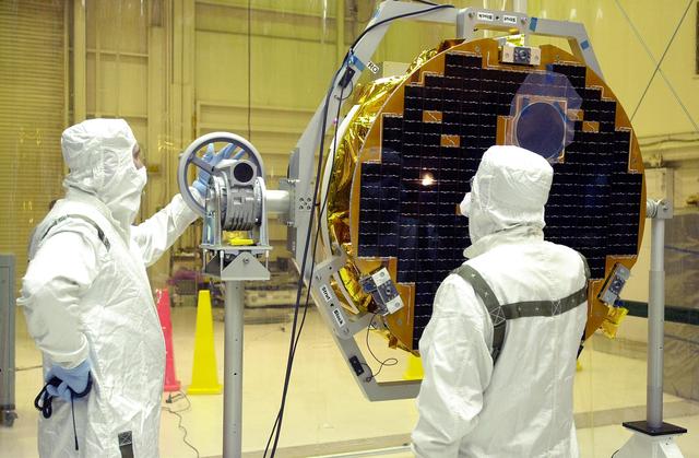 NASA image: VANDENBERG AIR FORCE BASE, CALIF. -  At Vandenberg AFB, Calif., a solar array is tested before installing on the SciSat-1 spacecraft.  The SciSat-1 weighs approximately 330 pounds and after launch will be placed in a 400-mile-high polar orbit to investigate processes that control the distribution of ozone in the upper atmosphere. The data from the satellite will provide Canadian and international scientists with improved measurements relating to global ozone processes and help policymakers assess existing environmental policy and develop protective measures for improving the health of our atmosphere, preventing further ozone depletion. The mission is designed to last two years.