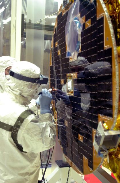 NASA image: VANDENBERG AIR FORCE BASE, CALIF. -  At Vandenberg AFB, Calif., a solar array is tested before installing on the SciSat-1 spacecraft.  The SciSat-1 weighs approximately 330 pounds and after launch will be placed in a 400-mile-high polar orbit to investigate processes that control the distribution of ozone in the upper atmosphere. The data from the satellite will provide Canadian and international scientists with improved measurements relating to global ozone processes and help policymakers assess existing environmental policy and develop protective measures for improving the health of our atmosphere, preventing further ozone depletion. The mission is designed to last two years.