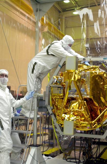 NASA image: VANDENBERG AIR FORCE BASE, CALIF. -  At Vandenberg AFB, Calif., a solar array is installed on the SciSat-1 spacecraft.  The SciSat-1 weighs approximately 330 pounds and after launch will be placed in a 400-mile-high polar orbit to investigate processes that control the distribution of ozone in the upper atmosphere. The data from the satellite will provide Canadian and international scientists with improved measurements relating to global ozone processes and help policymakers assess existing environmental policy and develop protective measures for improving the health of our atmosphere, preventing further ozone depletion. The mission is designed to last two years.