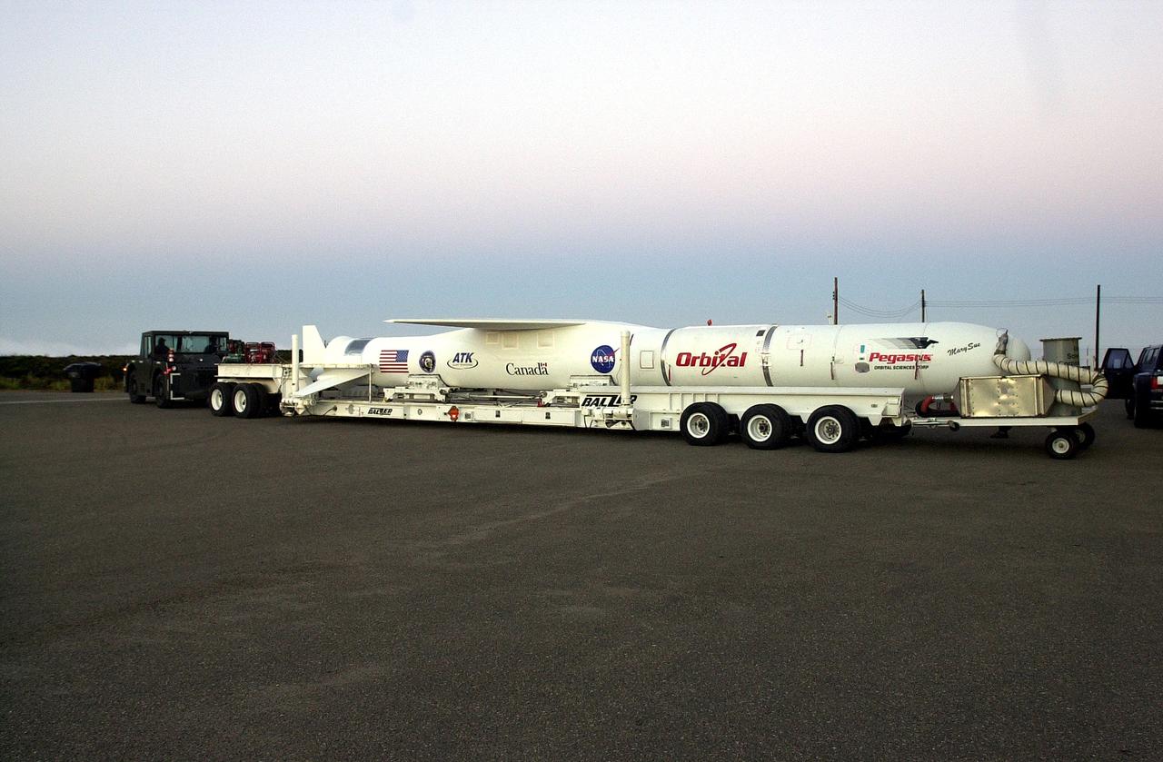 VANDENBERG AIR FORCE BASE, CALIF. -  The SciSat-1 payload, with fairing installed and attached to its Pegasus launch vehicle, begins rollout to the hot pad and mating to the L-1011 carrier aircraft.  The SciSat-1 weighs approximately 330 pounds and after launch will be placed in a 400-mile-high polar orbit to investigate processes that control the distribution of ozone in the upper atmosphere. The data from the satellite will provide Canadian and international scientists with improved measurements relating to global ozone processes and help policymakers assess existing environmental policy and develop protective measures for improving the health of our atmosphere, preventing further ozone depletion. The mission is designed to last two years.
