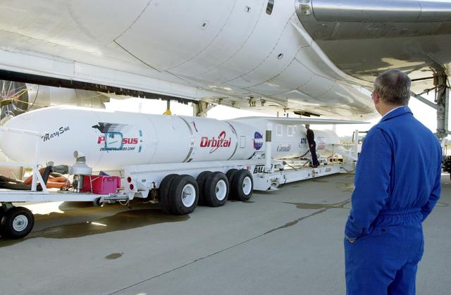 NASA image: VANDENBERG AIR FORCE BASE, CALIF. - The Pegasus transporter, with its cargo of  the SciSat-1 payload and Pegasus launch vehicle, moves under the L-1011 carrier aircraft for matting.  The SciSat-1 weighs approximately 330 pounds and after launch will be placed in a 400-mile-high polar orbit to investigate processes that control the distribution of ozone in the upper atmosphere. The data from the satellite will provide Canadian and international scientists with improved measurements relating to global ozone processes and help policymakers assess existing environmental policy and develop protective measures for improving the health of our atmosphere, preventing further ozone depletion. The mission is designed to last two years.