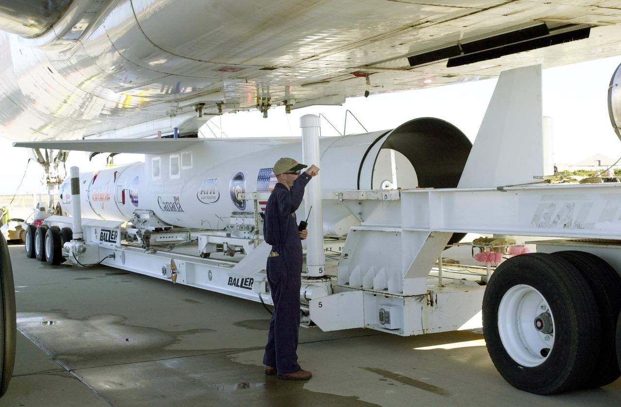 VANDENBERG AIR FORCE BASE, CALIF. -  The Pegasus transporter, with its cargo of  the SciSat-1 payload and Pegasus launch vehicle, moves under the L-1011 carrier aircraft for matting.  The SciSat-1 weighs approximately 330 pounds and after launch will be placed in a 400-mile-high polar orbit to investigate processes that control the distribution of ozone in the upper atmosphere. The data from the satellite will provide Canadian and international scientists with improved measurements relating to global ozone processes and help policymakers assess existing environmental policy and develop protective measures for improving the health of our atmosphere, preventing further ozone depletion. The mission is designed to last two years.