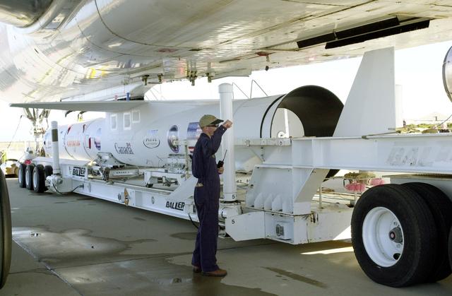 NASA image: VANDENBERG AIR FORCE BASE, CALIF. -  The Pegasus transporter, with its cargo of  the SciSat-1 payload and Pegasus launch vehicle, moves under the L-1011 carrier aircraft for matting.  The SciSat-1 weighs approximately 330 pounds and after launch will be placed in a 400-mile-high polar orbit to investigate processes that control the distribution of ozone in the upper atmosphere. The data from the satellite will provide Canadian and international scientists with improved measurements relating to global ozone processes and help policymakers assess existing environmental policy and develop protective measures for improving the health of our atmosphere, preventing further ozone depletion. The mission is designed to last two years.