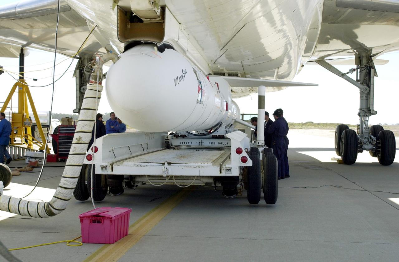 VANDENBERG AIR FORCE BASE, CALIF. -  The SciSat-1 payload and Pegasus launch vehicle are lifted and mated to the L-1011 carrier aircraft.  The SciSat-1 weighs approximately 330 pounds and after launch will be placed in a 400-mile-high polar orbit to investigate processes that control the distribution of ozone in the upper atmosphere. The data from the satellite will provide Canadian and international scientists with improved measurements relating to global ozone processes and help policymakers assess existing environmental policy and develop protective measures for improving the health of our atmosphere, preventing further ozone depletion. The mission is designed to last two years.