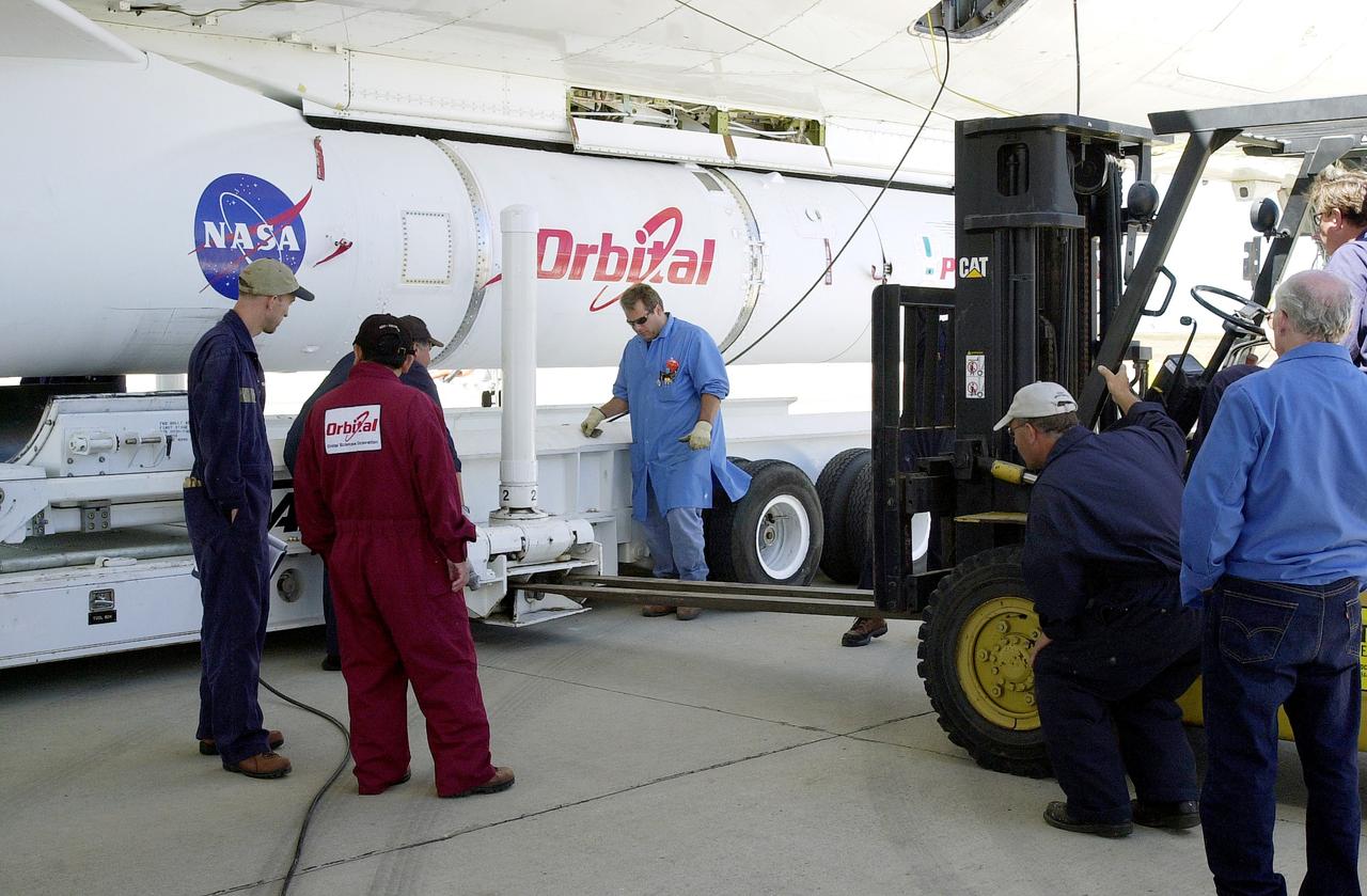 VANDENBERG AIR FORCE BASE, CALIF. -  The SciSat-1 payload and Pegasus launch vehicle are lifted and mated to the L-1011 carrier aircraft.  The SciSat-1 weighs approximately 330 pounds and after launch will be placed in a 400-mile-high polar orbit to investigate processes that control the distribution of ozone in the upper atmosphere. The data from the satellite will provide Canadian and international scientists with improved measurements relating to global ozone processes and help policymakers assess existing environmental policy and develop protective measures for improving the health of our atmosphere, preventing further ozone depletion. The mission is designed to last two years.