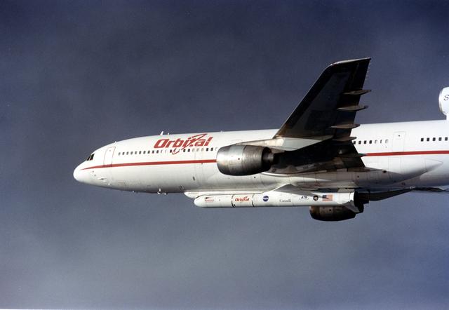 NASA image: VANDENBERG AIR FORCE BASE, CALIF. -  The L-1011 carrier aircraft is in flight with its cargo underneath of the Pegasus launch vehicle and SciSat-1 spacecraft.  The SciSat-1 weighs approximately 330 pounds and after launch will be placed in a 400-mile-high polar orbit to investigate processes that control the distribution of ozone in the upper atmosphere. The data from the satellite will provide Canadian and international scientists with improved measurements relating to global ozone processes and help policymakers assess existing environmental policy and develop protective measures for improving the health of our atmosphere, preventing further ozone depletion. The mission is designed to last two years.
