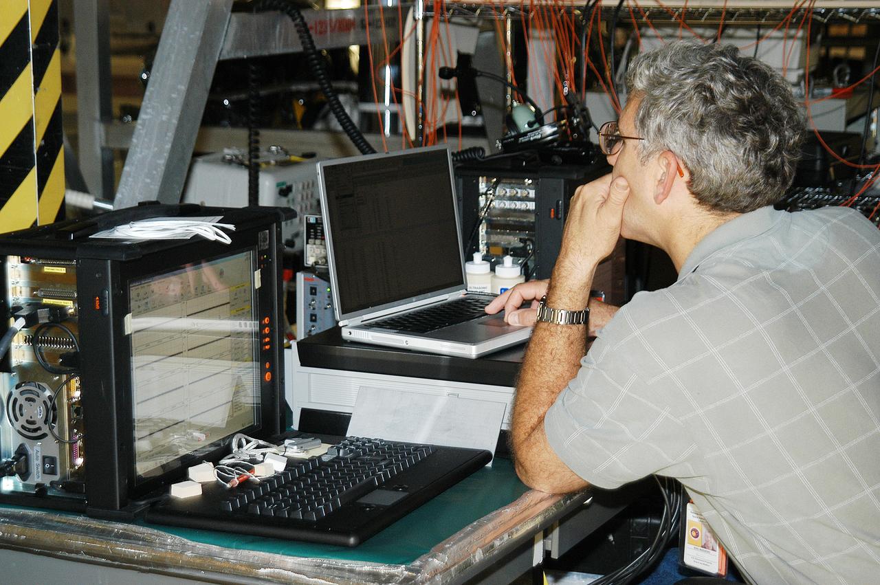 In the Orbiter Processing Facility, Eric Madaras, NASA-Langley Research Center, conducts impulse tests on the right wing leading edge (WLE) of Space Shuttle Endeavour. The tests monitor how sound impulses propagate through the WLE area. The data collected will be analyzed to explore the possibility of adding new instrumentation to the wing that could automatically detect debris or micrometeroid impacts on the Shuttle while in flight. The study is part of the initiative ongoing at KSC and around the agency to return the orbiter fleet to flight status.