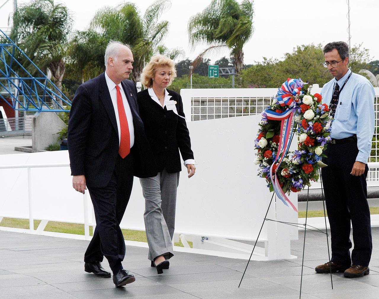 KENNEDY SPACE CENTER, FLA. -  NASA's Associate Administrator for Space Flight William Readdy (left) and Evelyn Husband, widow of astronaut Rick Husband, place a ceremonial wreath at the Space Mirror Memorial at the Kennedy Space Center Visitor Complex.  During this dedication ceremony, the names of the STS-107 astronauts who lost their lives during the Columbia accident -- Rick Husband, Willie McCool, Laurel Clark, Michael Anderson, David Brown, Kalpana Chawla, and Ilan Ramon -- join the names of 17 other space heroes who gave their lives for the U.S. space program. The "Space Mirror," 42 1/2 feet high by 50 feet wide, illuminates the names of the fallen astronauts cut through the monument's black granite surface.