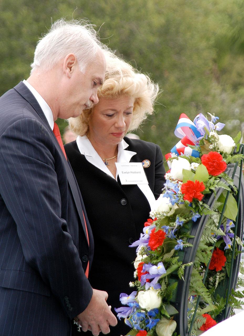 KENNEDY SPACE CENTER, FLA. -  NASA's Associate Administrator for Space Flight William Readdy and Evelyn Husband, widow of astronaut Rick Husband, place a ceremonial wreath at the Space Mirror Memorial at the Kennedy Space Center Visitor Complex.  During this dedication ceremony, the names of the STS-107 astronauts who lost their lives during the Columbia accident -- Rick Husband, Willie McCool, Laurel Clark, Michael Anderson, David Brown, Kalpana Chawla, and Ilan Ramon -- join the names of 17 other space heroes who gave their lives for the U.S. space program. The "Space Mirror," 42 1/2 feet high by 50 feet wide, illuminates the names of the fallen astronauts cut through the monument's black granite surface.