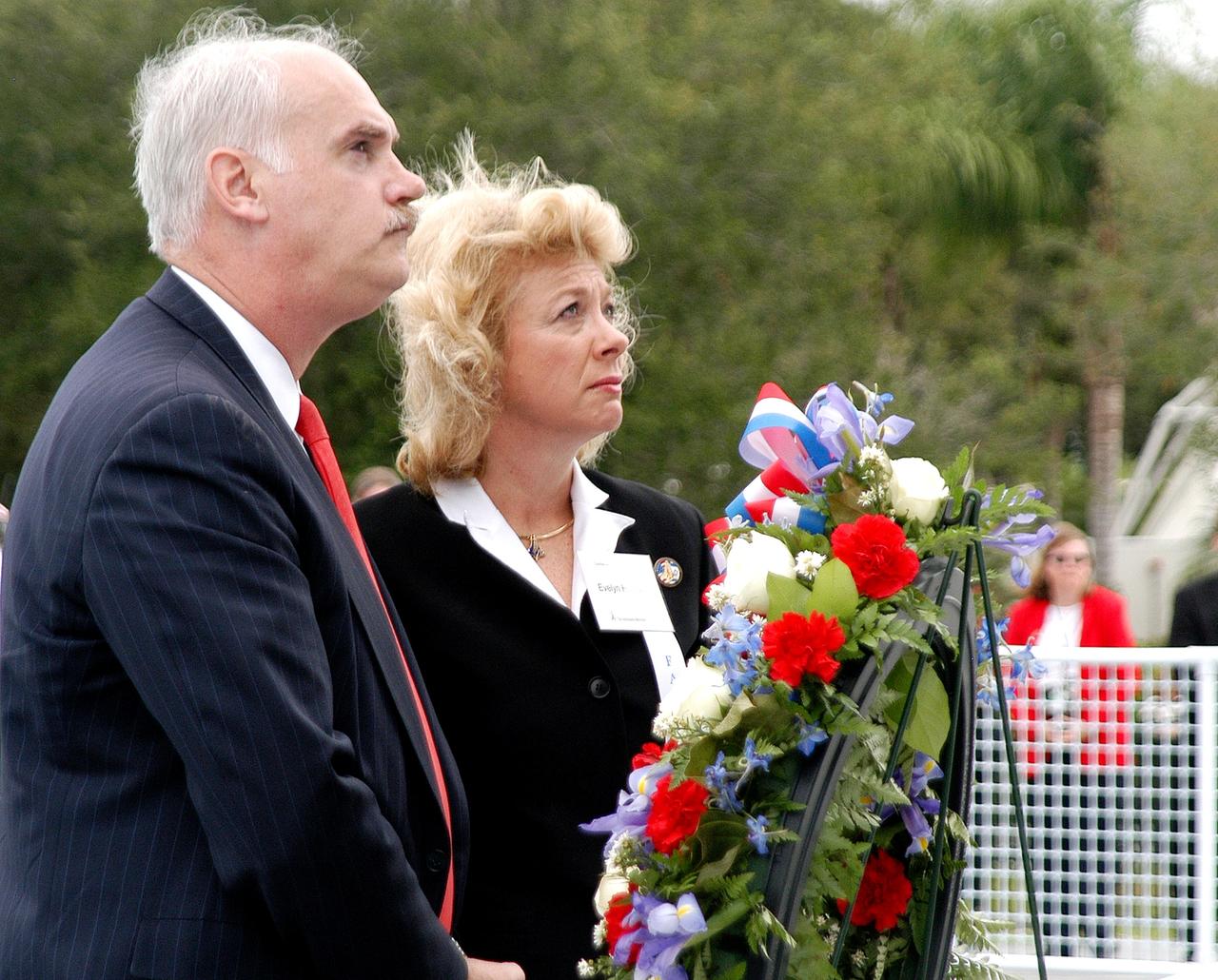 KENNEDY SPACE CENTER, FLA. -  NASA's Associate Administrator for Space Flight William Readdy and Evelyn Husband, widow of astronaut Rick Husband, place a ceremonial wreath at the Space Mirror Memorial at the Kennedy Space Center Visitor Complex.  During this dedication ceremony, the names of the STS-107 astronauts who lost their lives during the Columbia accident -- Rick Husband, Willie McCool, Laurel Clark, Michael Anderson, David Brown, Kalpana Chawla, and Ilan Ramon -- join the names of 17 other space heroes who gave their lives for the U.S. space program. The "Space Mirror," 42 1/2 feet high by 50 feet wide, illuminates the names of the fallen astronauts cut through the monument's black granite surface.