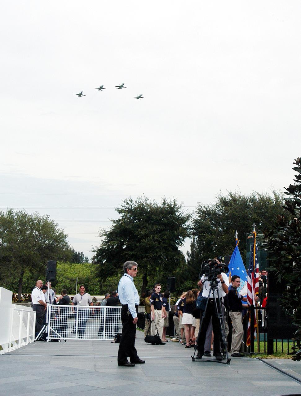 KENNEDY SPACE CENTER, FLA. -  NASA T-38 jets fly over the Space Mirror Memorial at the Kennedy Space Center Visitor Complex in the Missing Man Formation. During this dedication ceremony, the names of the STS-107 astronauts who lost their lives during the Columbia accident -- Rick Husband, Willie McCool, Laurel Clark, Michael Anderson, David Brown, Kalpana Chawla, and Ilan Ramon -- join the names of 17 other space heroes who gave their lives for the U.S. space program. The "Space Mirror," 42 1/2 feet high by 50 feet wide, illuminates the names of the fallen astronauts cut through the monument's black granite surface.