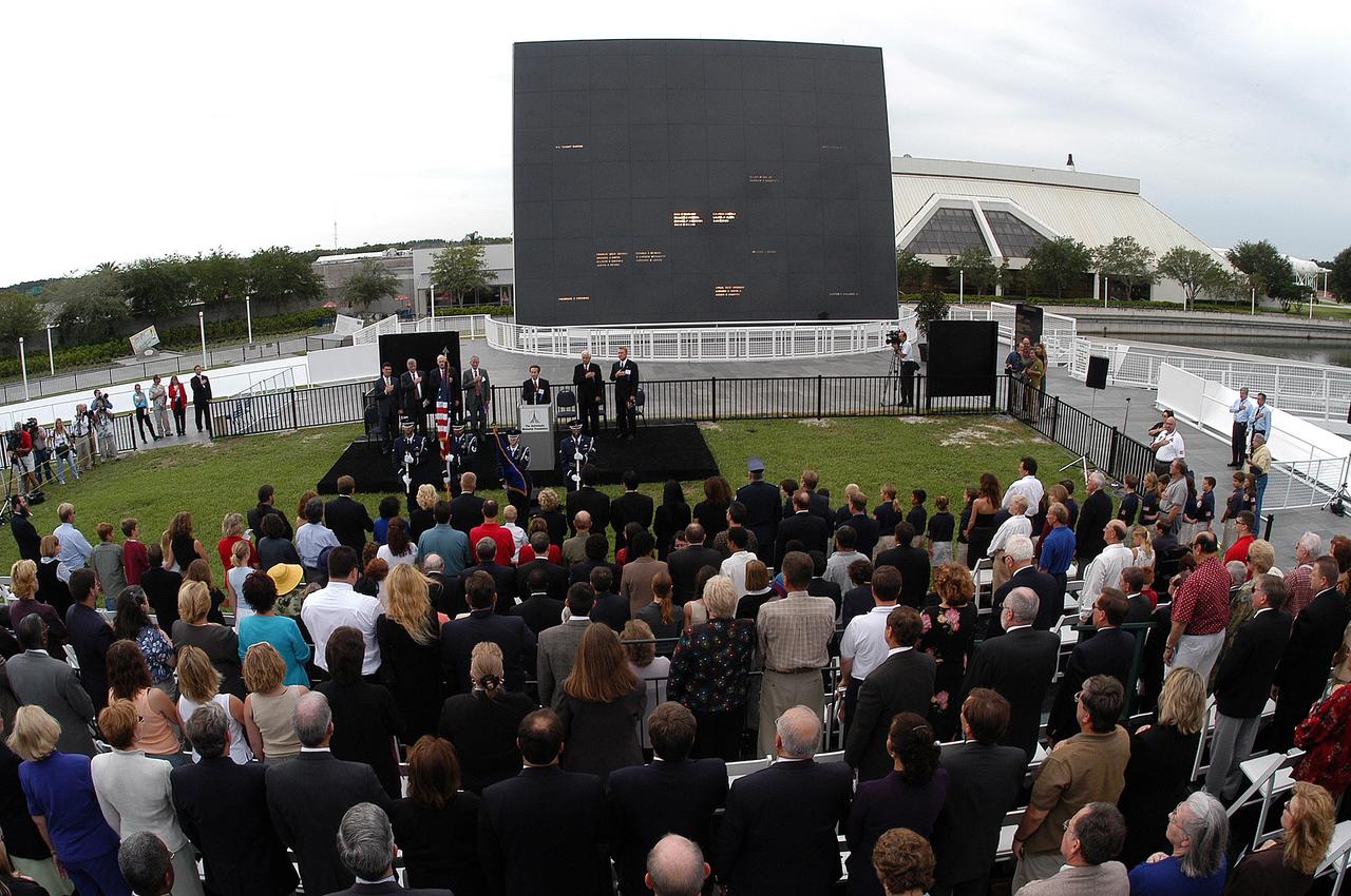KENNEDY SPACE CENTER, FLA. -  Family members of the STS-107 astronauts and other dignitaries attend a dedication ceremony at the Space Mirror Memorial at the Kennedy Space Center Visitor Complex.  During this solemn event, the names of the STS-107 astronauts who lost their lives during the Columbia accident -- Rick Husband, Willie McCool, Laurel Clark, Michael Anderson, David Brown, Kalpana Chawla, and Ilan Ramon -- join the names of 17 other space heroes who gave their lives for the U.S. space program. The "Space Mirror," 42 1/2 feet high by 50 feet wide, illuminates the names of the fallen astronauts cut through the monument's black granite surface.