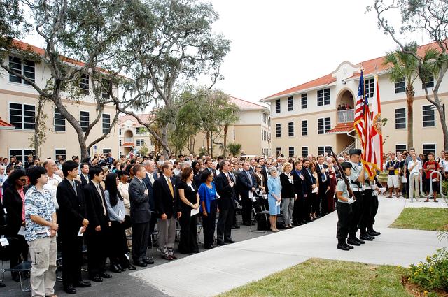 NASA image: KENNEDY SPACE CENTER, FLA. -  Family members of the STS-107 astronauts and other dignitaries attending the Columbia Village dedication ceremony at the Florida Institute of Technology in Melbourne, Fla., stand for the posting of the colors by members of the university's ROTC.  Each of the seven new residence halls in the complex is named for one of the STS-107 astronauts who perished during the Columbia accident -- Rick Husband, Willie McCool, Laurel Clark, Michael Anderson, David Brown, Kalpana Chawla, and Ilan Ramon.