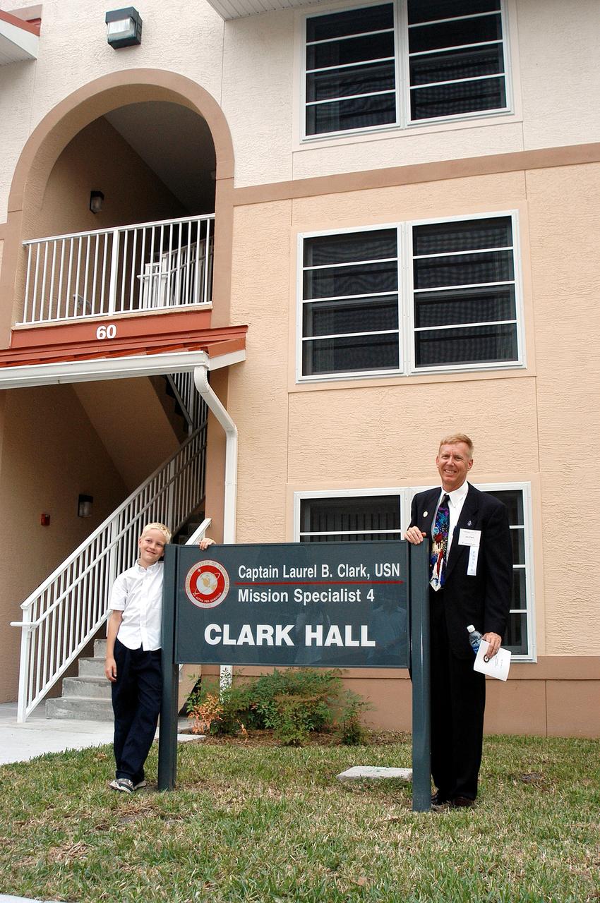 KENNEDY SPACE CENTER, FLA. -- Dr. Jonathan Clark (right), husband of STS-107 Mission Specialist Laurel Clark, and their son (left) visit a new residence hall at the Florida Institute of Technology (FIT) in Melbourne, Fla., named for his late wife.  Family members of the STS-107 astronauts, other dignitaries, members of the university community and the public gathered for a dedication ceremony for the Columbia Village at FIT.  Each of the seven new residence halls in the complex is named for one of the STS-107 astronauts who perished during the Columbia accident -- Rick Husband, Willie McCool, Laurel Clark, Michael Anderson, David Brown, Kalpana Chawla, and Ilan Ramon.